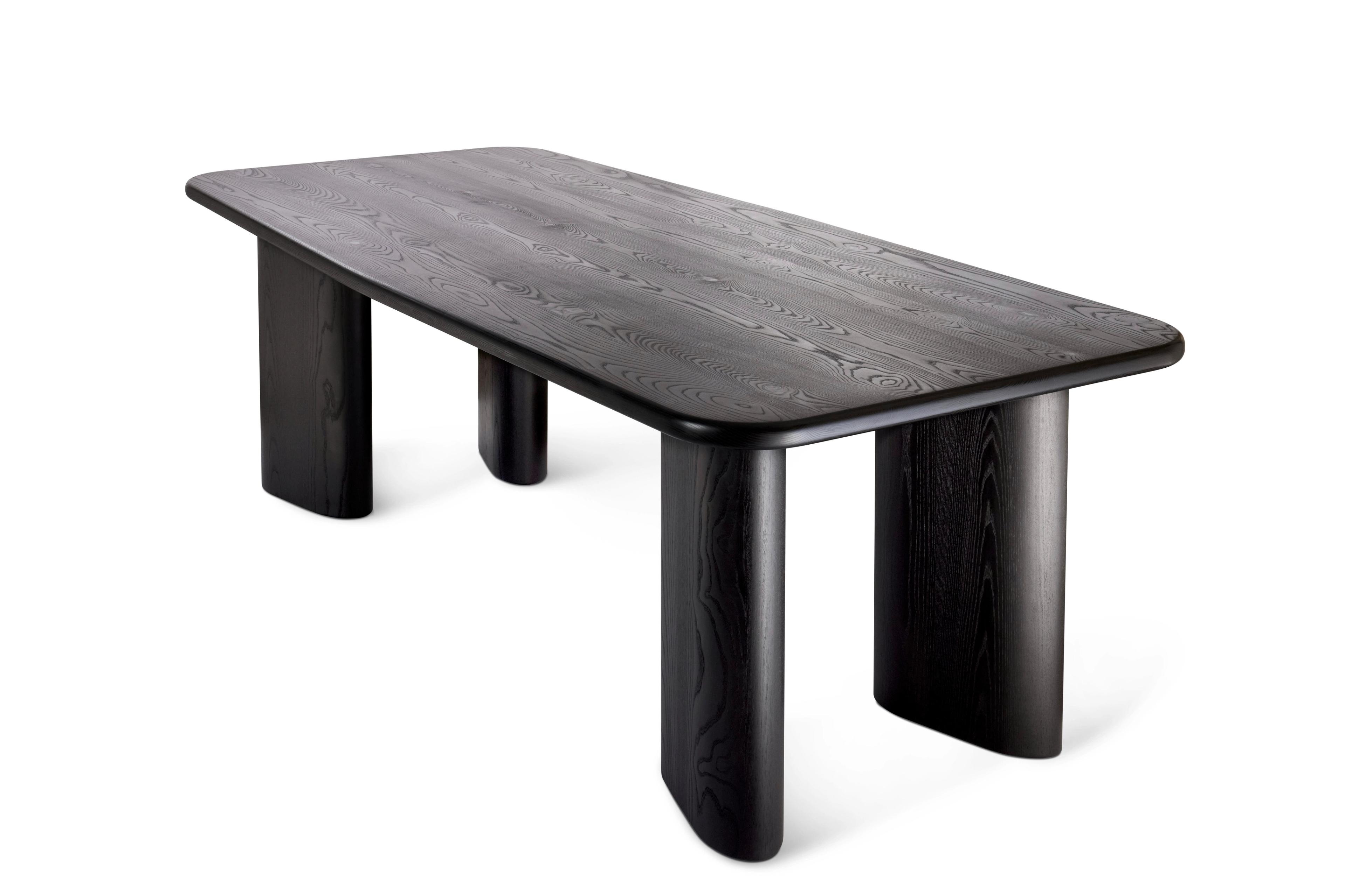 black oak dining table sculptural legs three quarter product photo