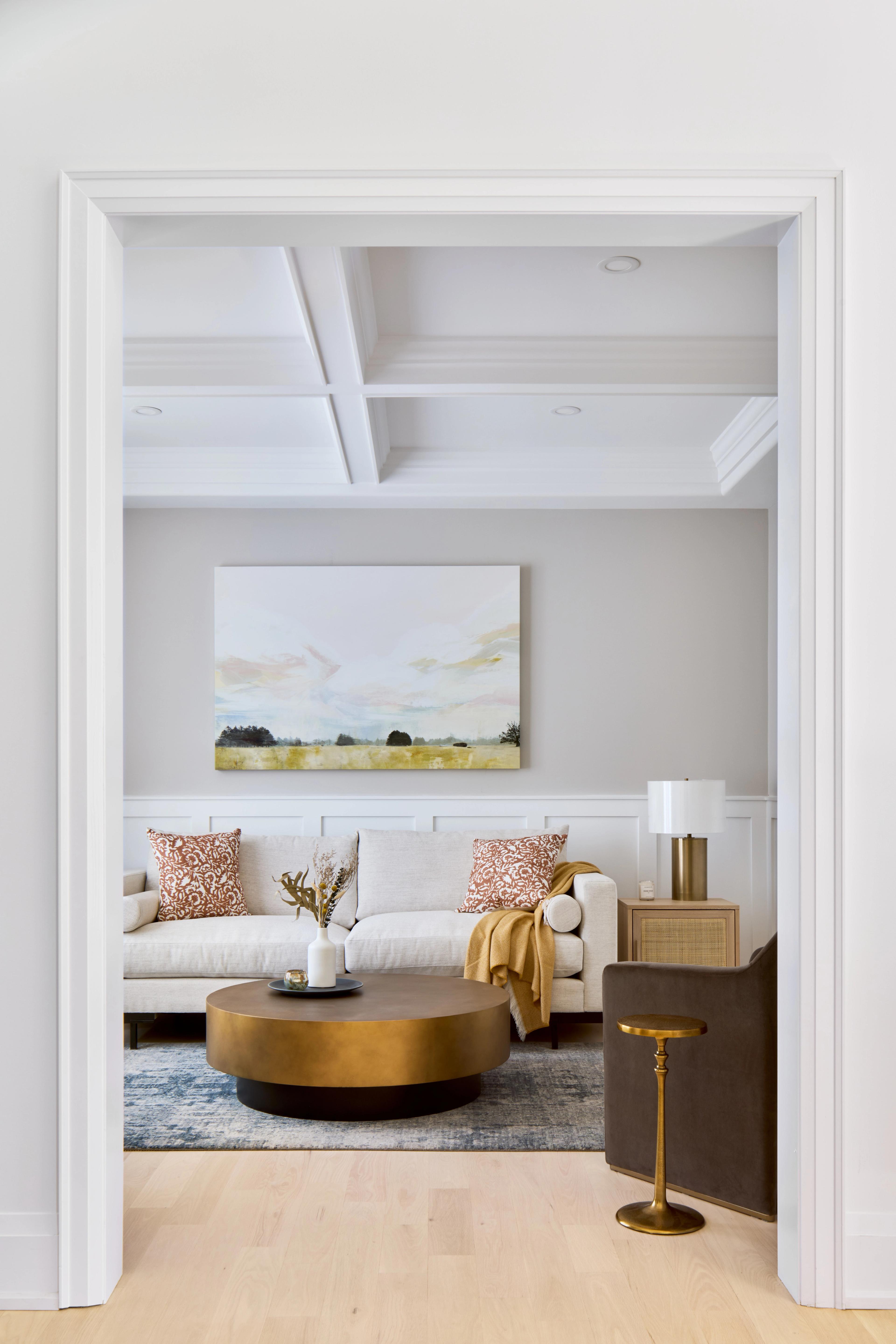 Living room with coffered ceiling and gold accents