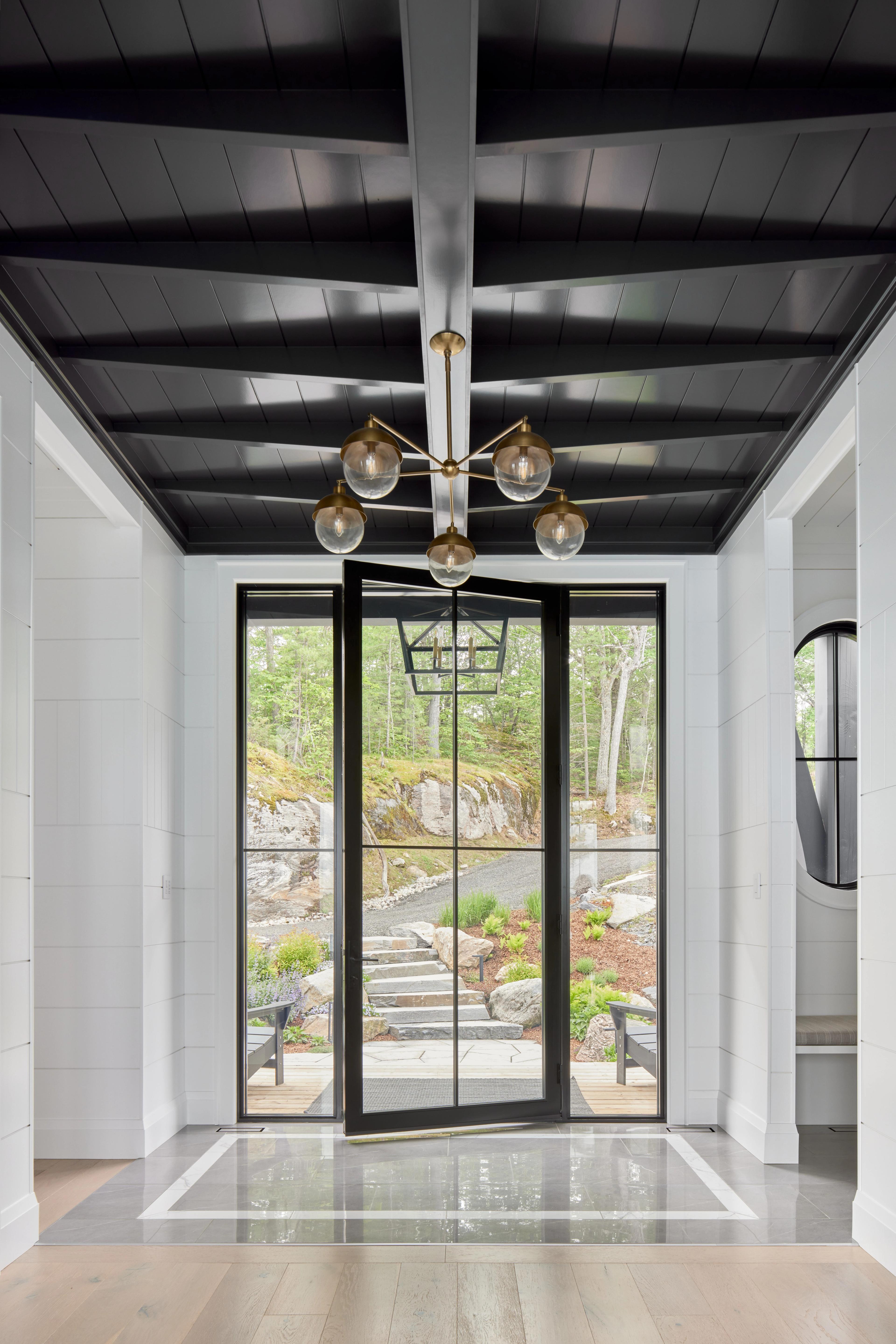 Glass entry door with dark ceiling detail