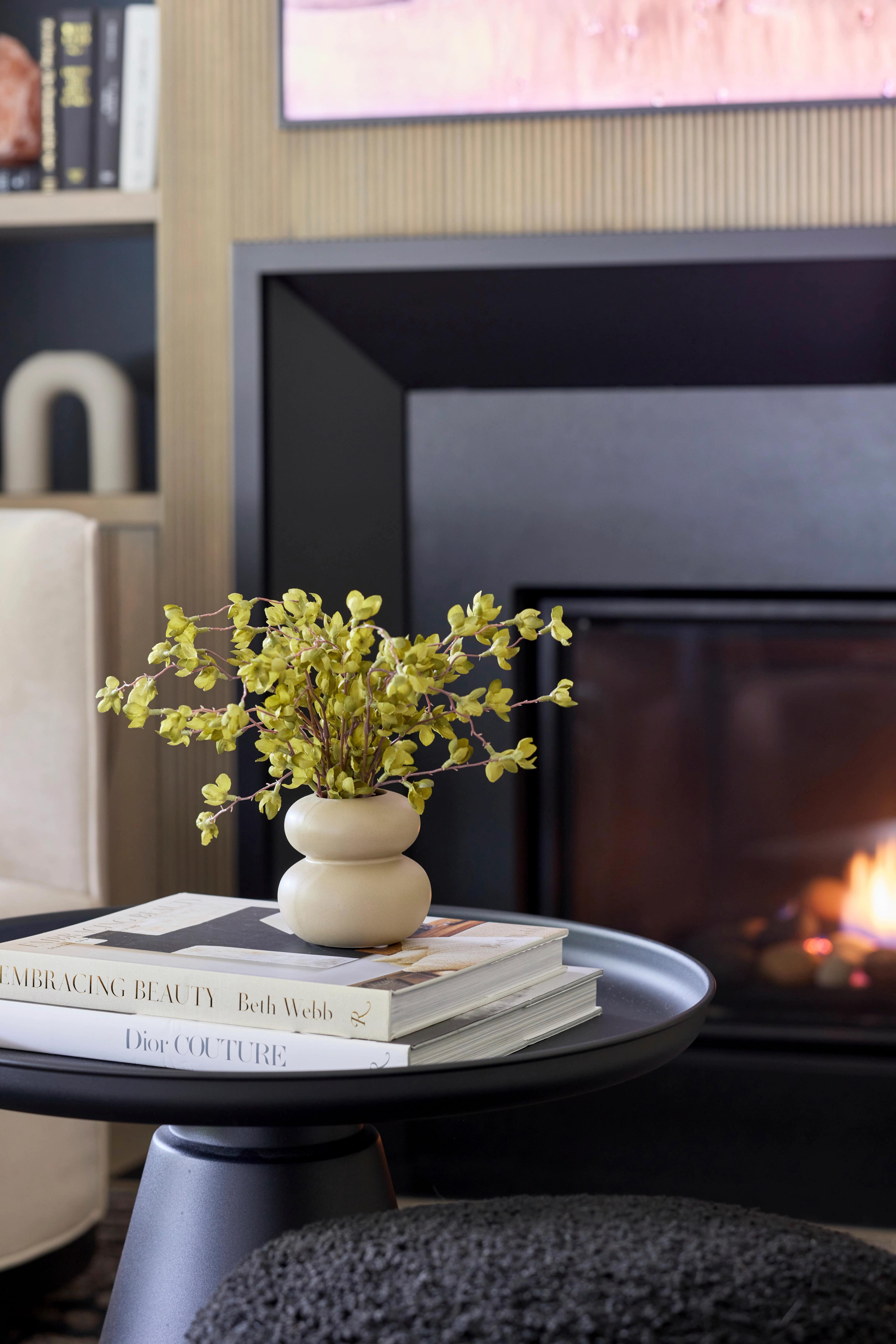 fireplace and a side table with vase 