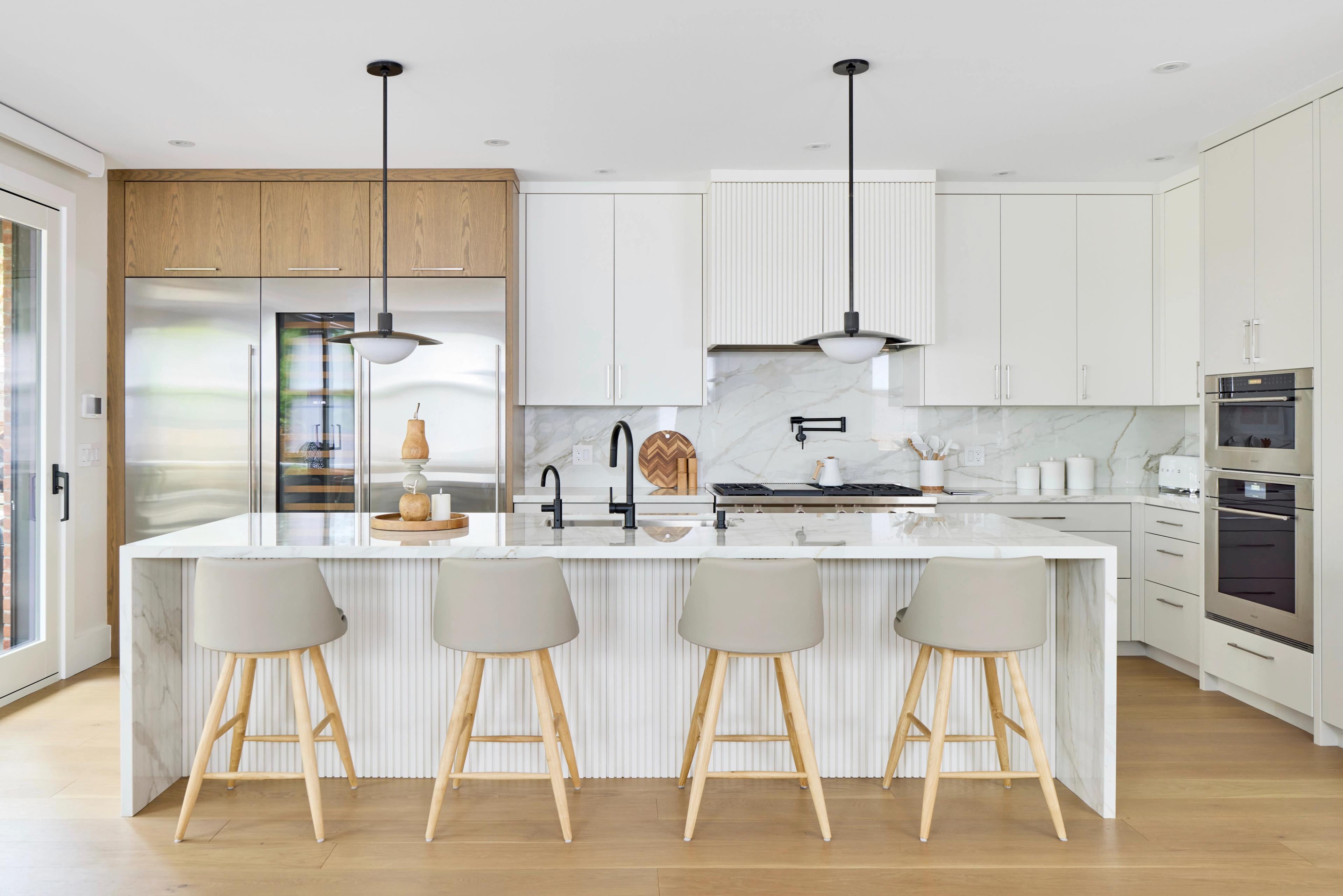 interior contemporary white kitchen island with bar stools and marble backsplash