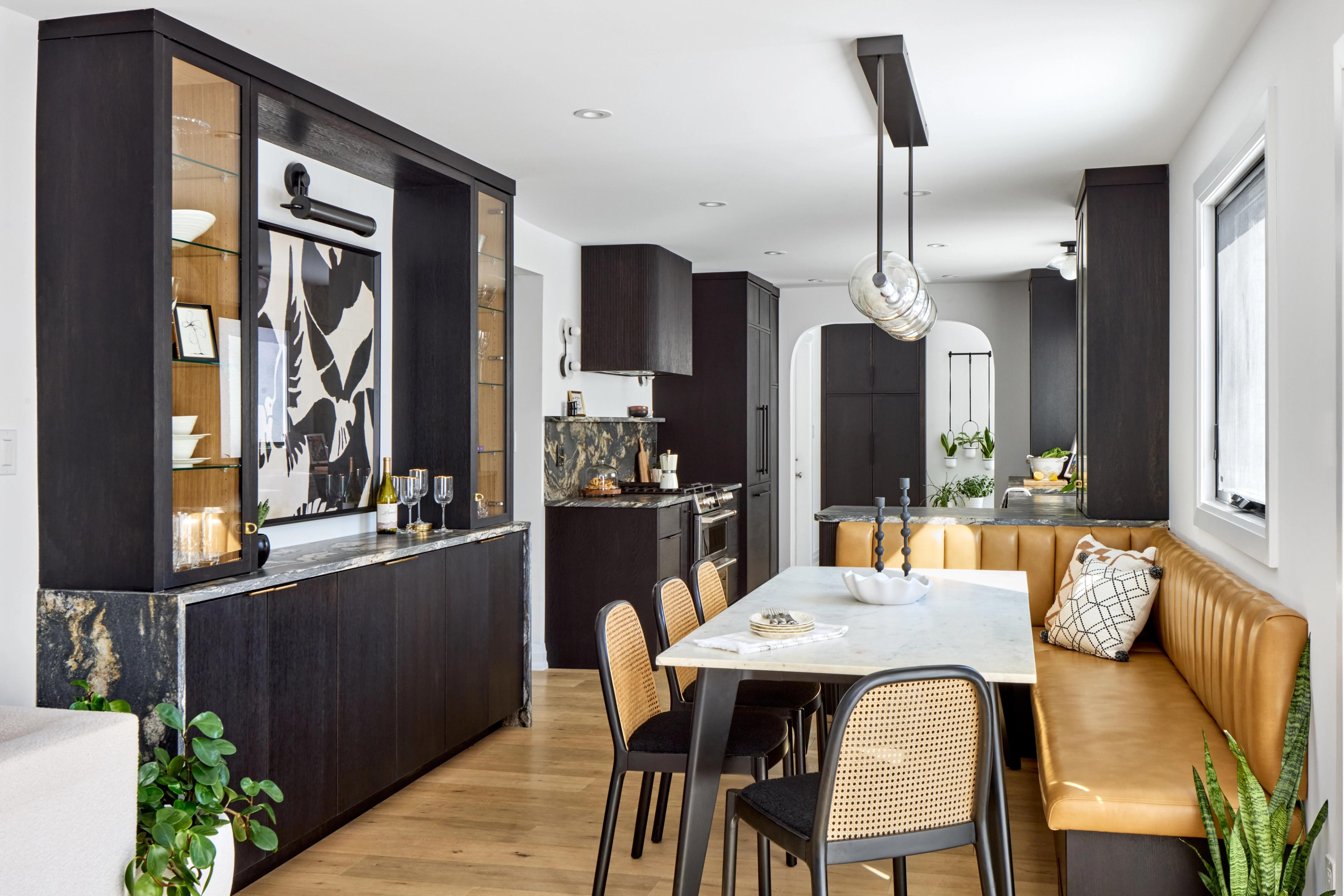 Clean kitchen design with banquet table and dark cabinets 