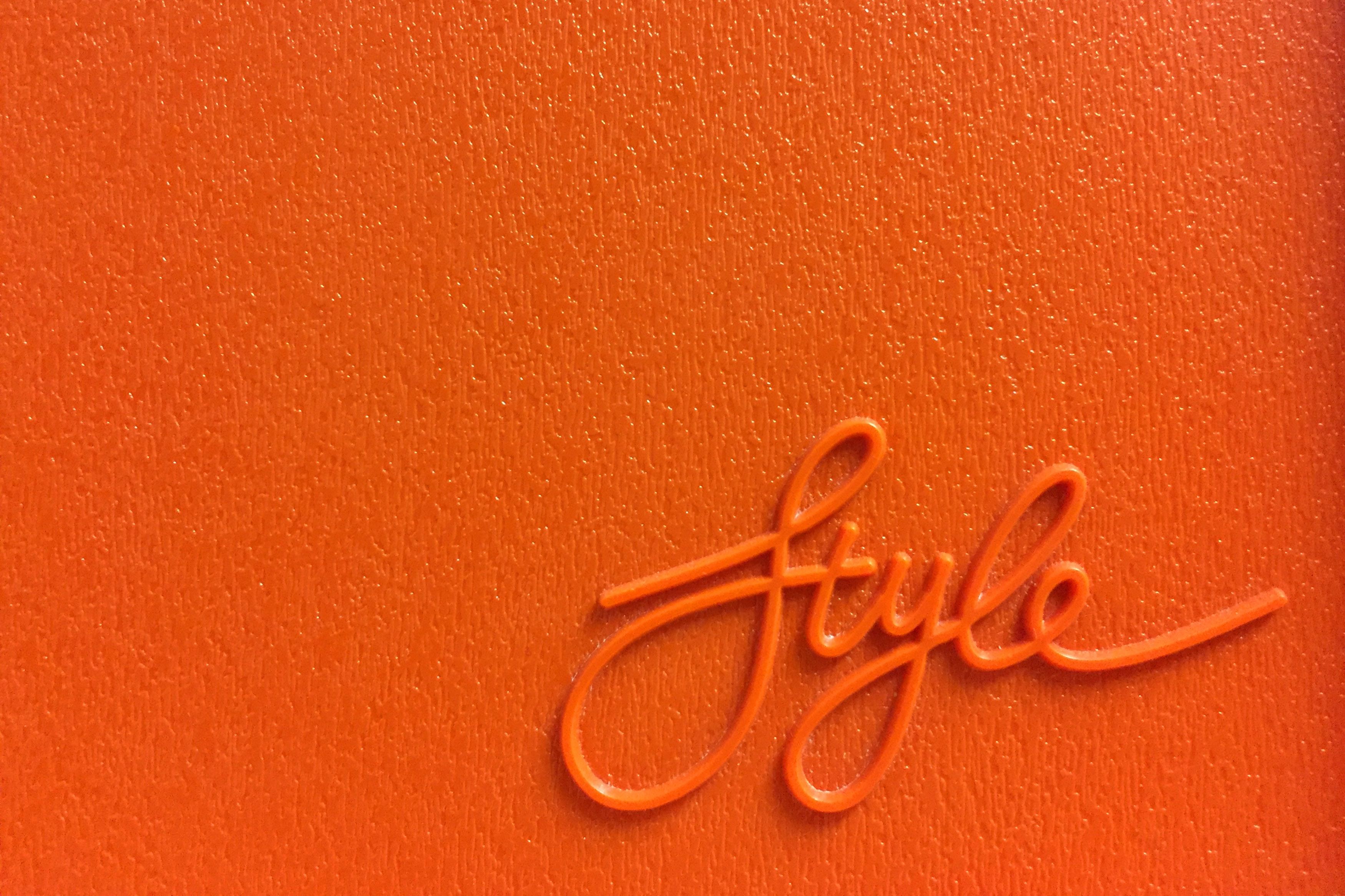 Image of Orange Style lettering on a vintage plastic board by Marcus Ganahl by Unsplash