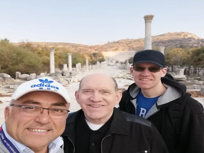 A private guide walking with guests along Harbour Street in Ephesus