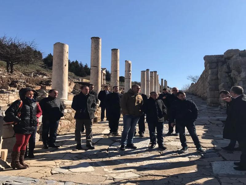 A private tour group walking down the column-lined Curetes Street in Ephesus