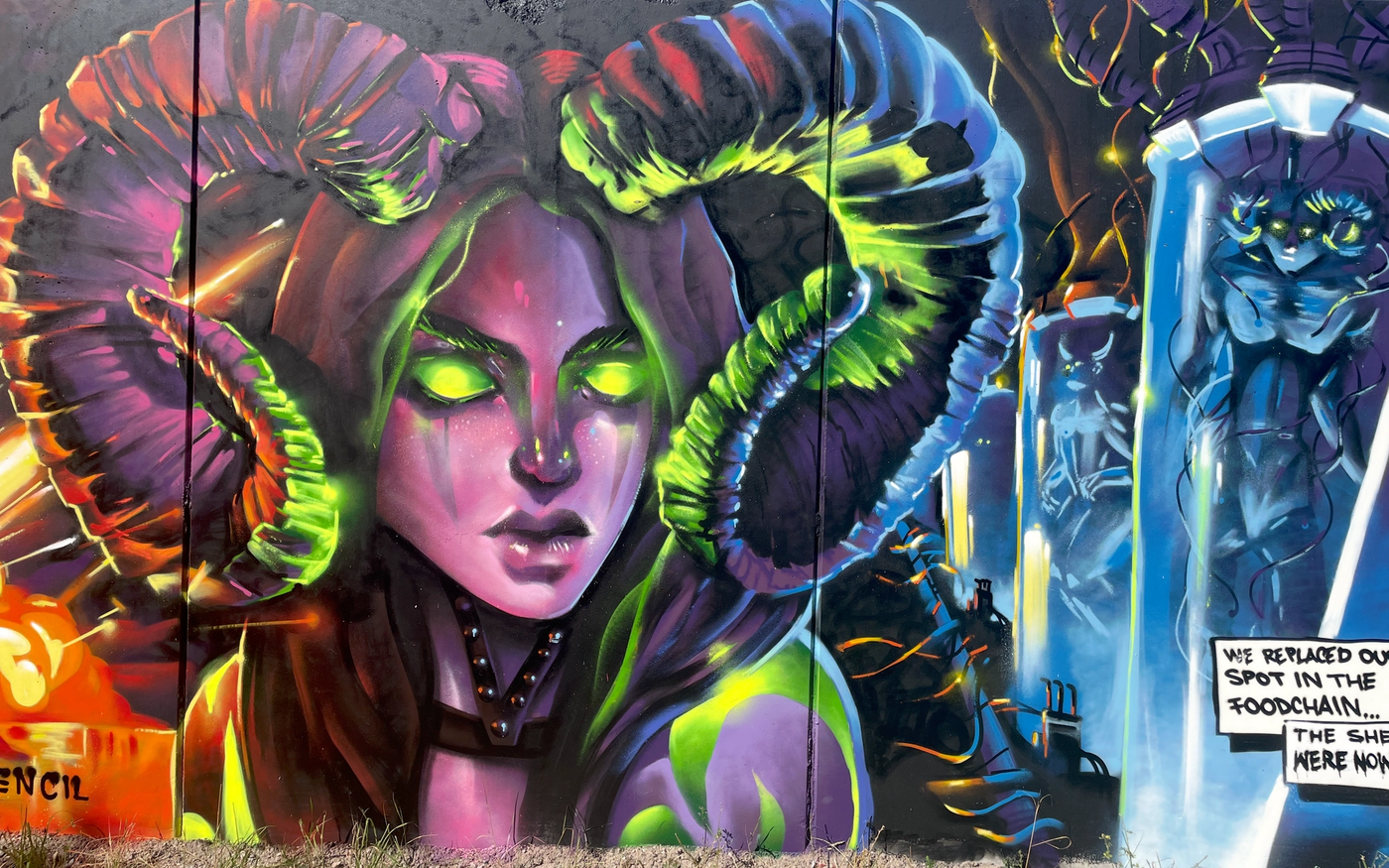Behornad varelse med lysande gröna ögon och provrör med muterade varelser, ur Raukonium-målningen i Visby. Horned creature with glowing green eyes and containment tubes holding mutated creatures, from The Raukonium Saga mural in Visby.