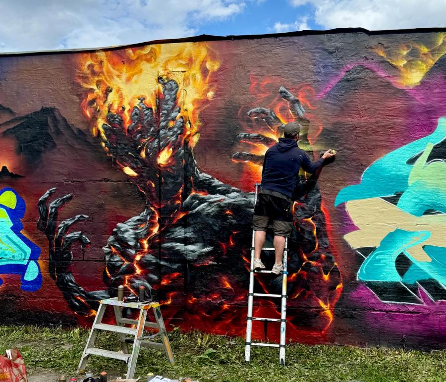 Burning Man — hand-painted mural by Spraya in Snösätra, Stockholm