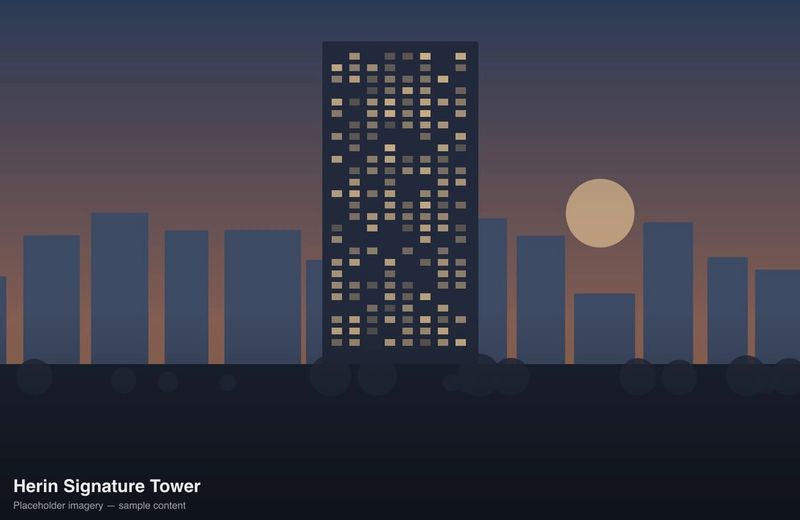 Herin Signature Tower lit at dusk