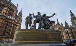 Bronze statue of three public service workers displayed outside the UK Houses of Parliament with a UNISON plaque.