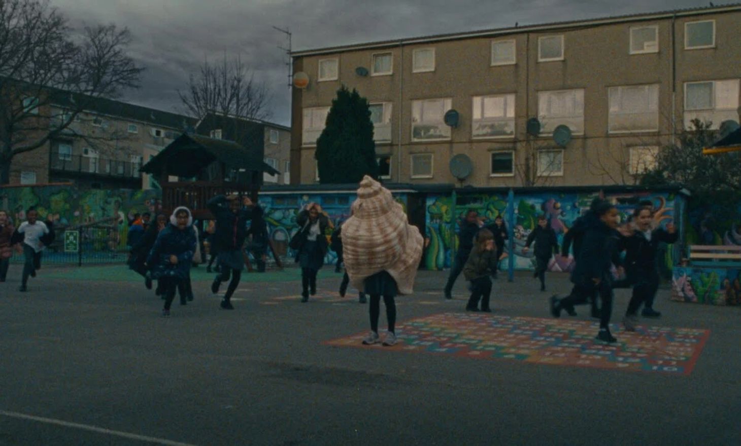 A child hiding in a seashell on the playground in Barnardo’s emotional advertising campaign