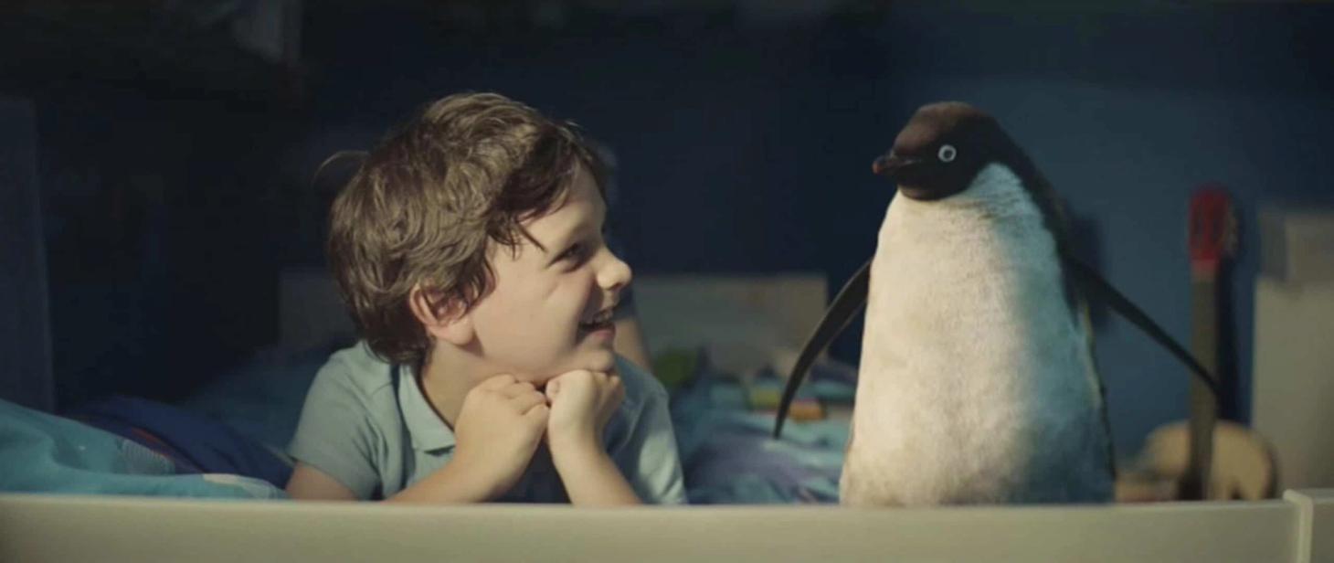 John Lewis Christmas advert with little boy smiling at a penguin