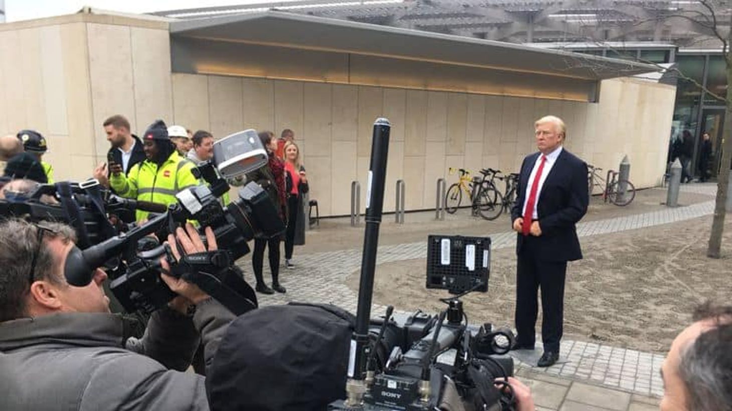 Donald Trump standing in front of news reporters