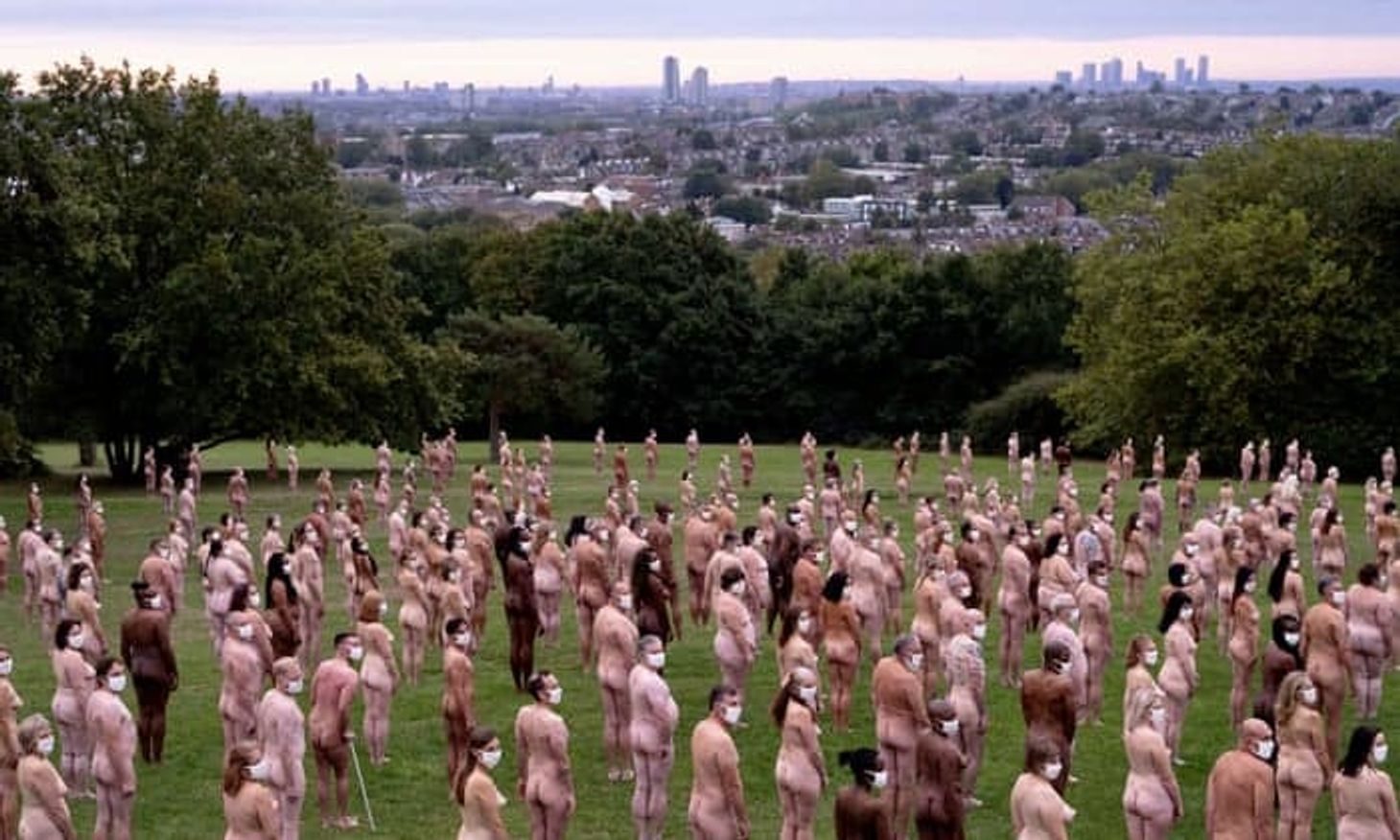 A group of people standing naked wearing covid face masks for Sky Arts project 'Everyone Together'