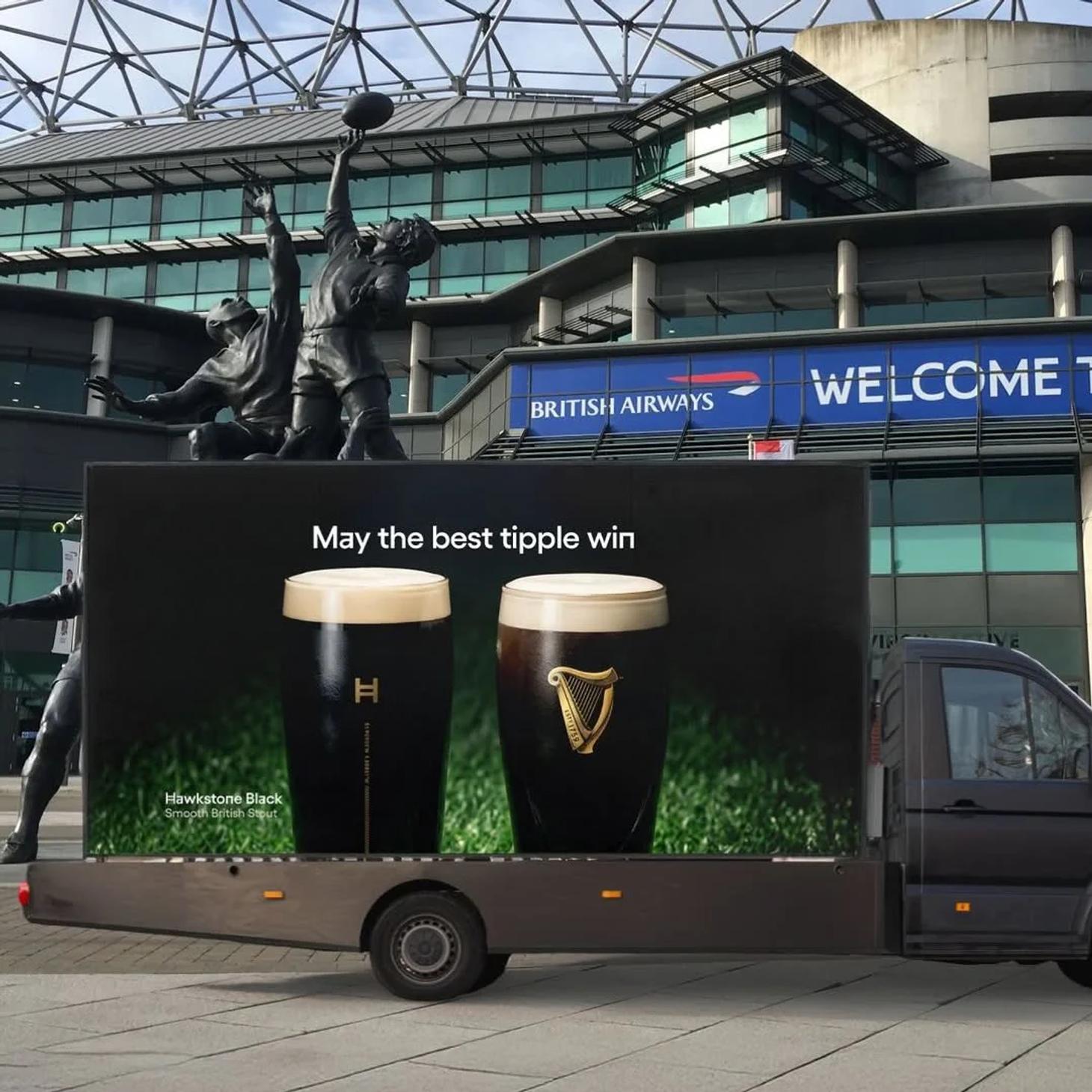 Van-side advert with a pint of Hawkstone Black next to a pint of Guinness, but the Guinness brand logo stands out most in an example of an advertising creativity fail