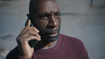 Still from the Don't Panic & Samaritans “Wedding Day” campaign film: A close-up of Michael, the father, making a crucial phone call that will become a life-saving turning point.