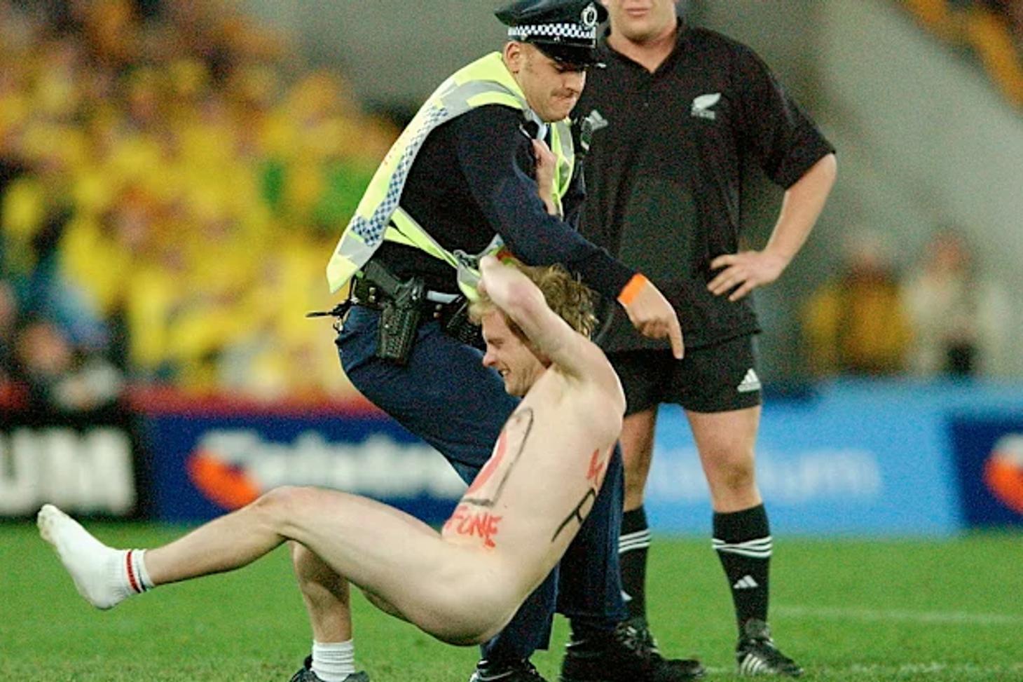 Police officer tackling a streaker painted with Vodafone's logo at the 2002 Bledisloe Cup in Sydney