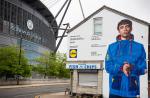 Lidl by Lidl parka mural of Oasis fan beside the Etihad, a Lidl PR campaign