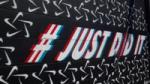 An image showing #JustDoIt wall mural for Nike, highlighting successful hybrid marketing examples.