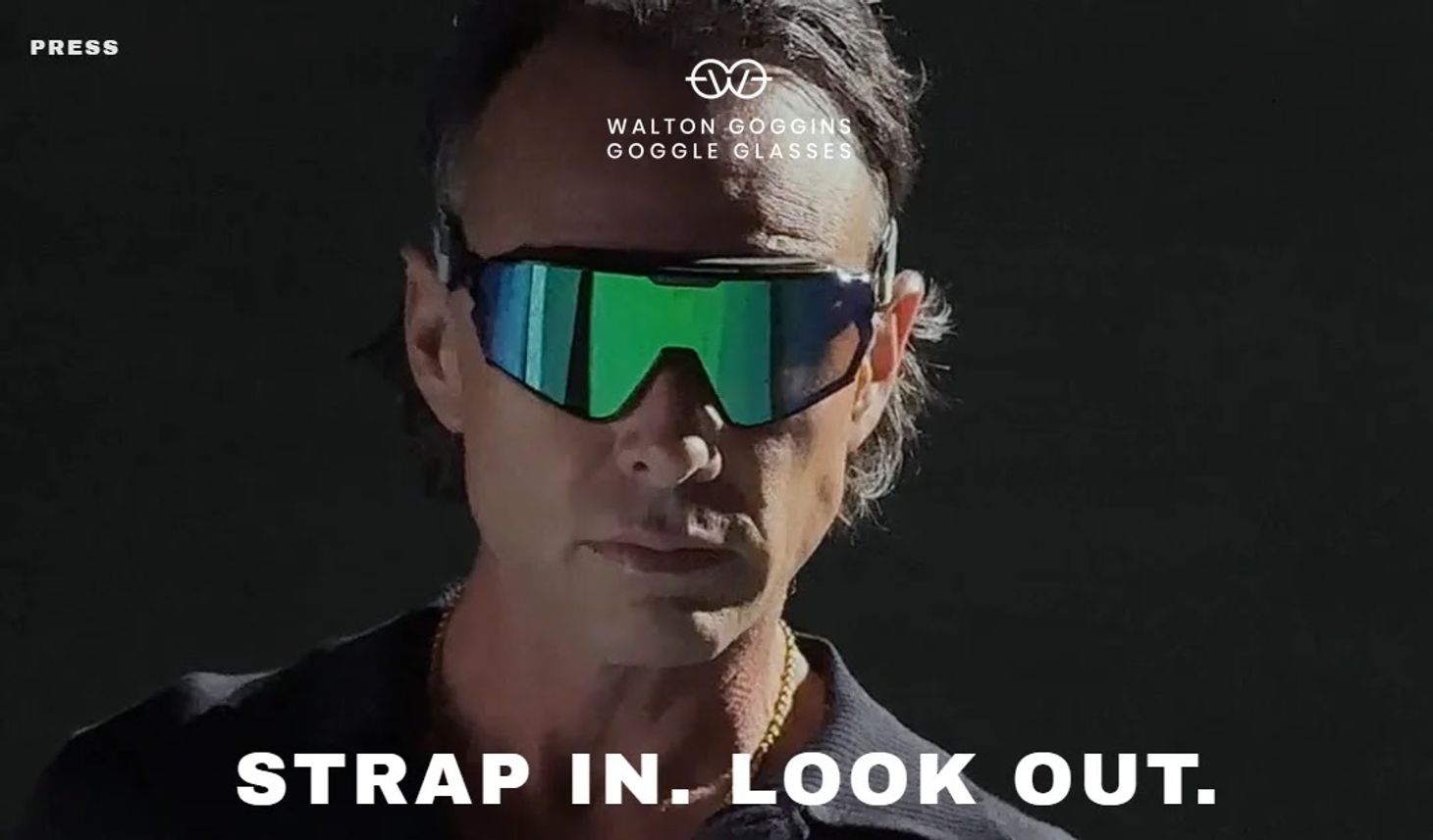 Walton Goggins wearing Goggle Glasses with the tagline reading “Strap in. Look out.”