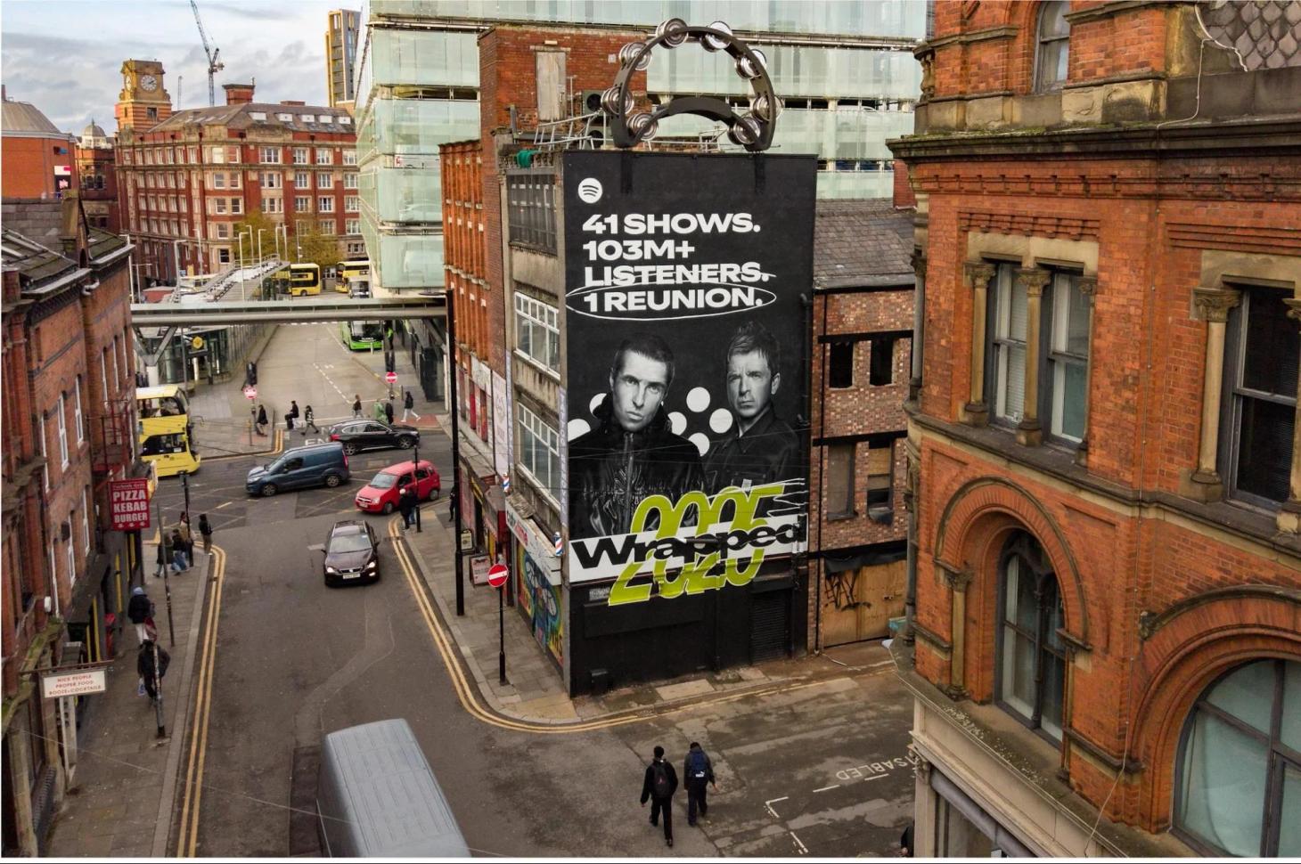 Spotify Wrapped 2025 Oasis building wrap with a giant tambourine on a Manchester street