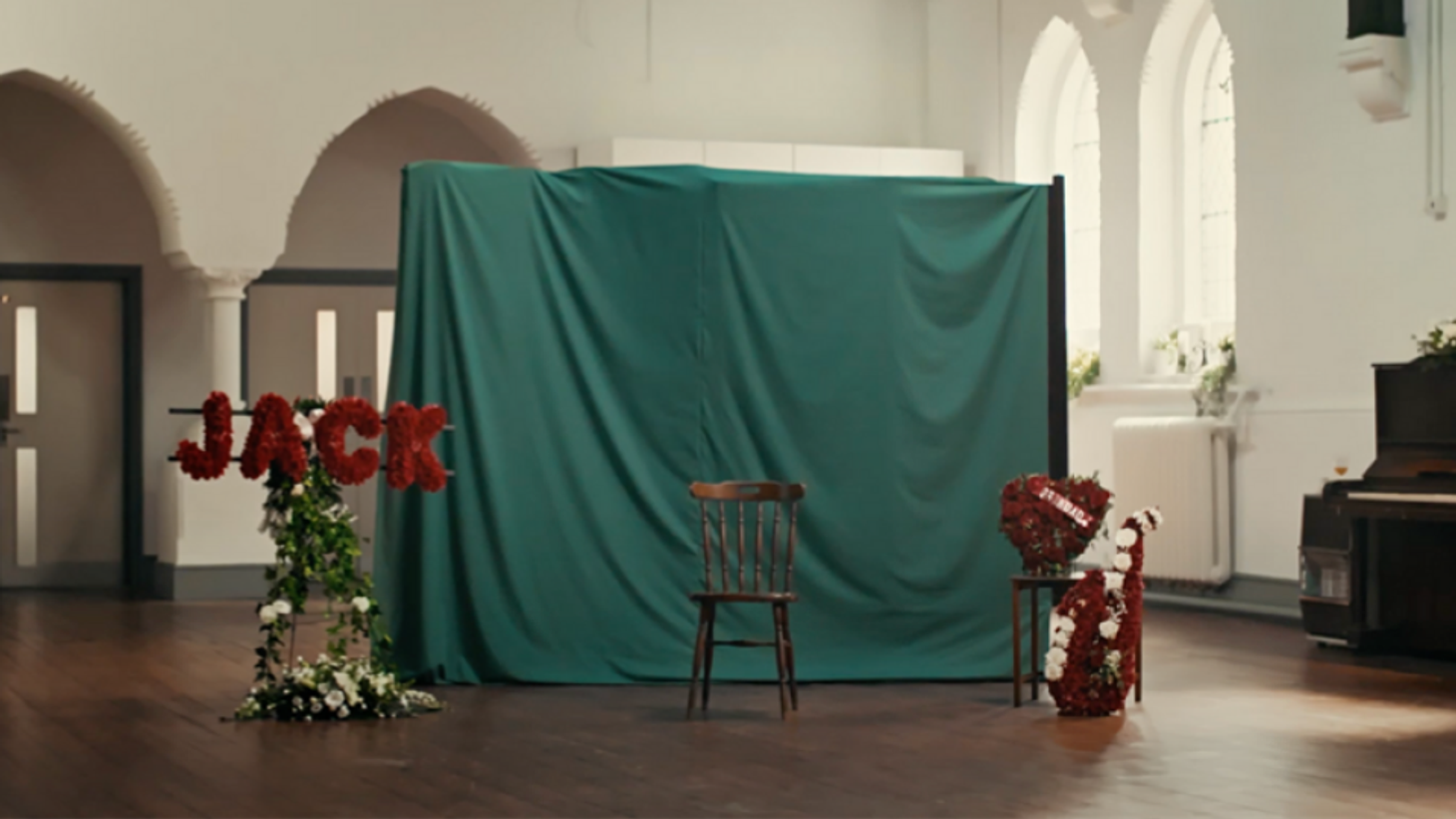 Still from WaterAid legacy campaign “What Jack Gave”, featuring a staged memorial setting that represents gifts in wills and lasting impact.