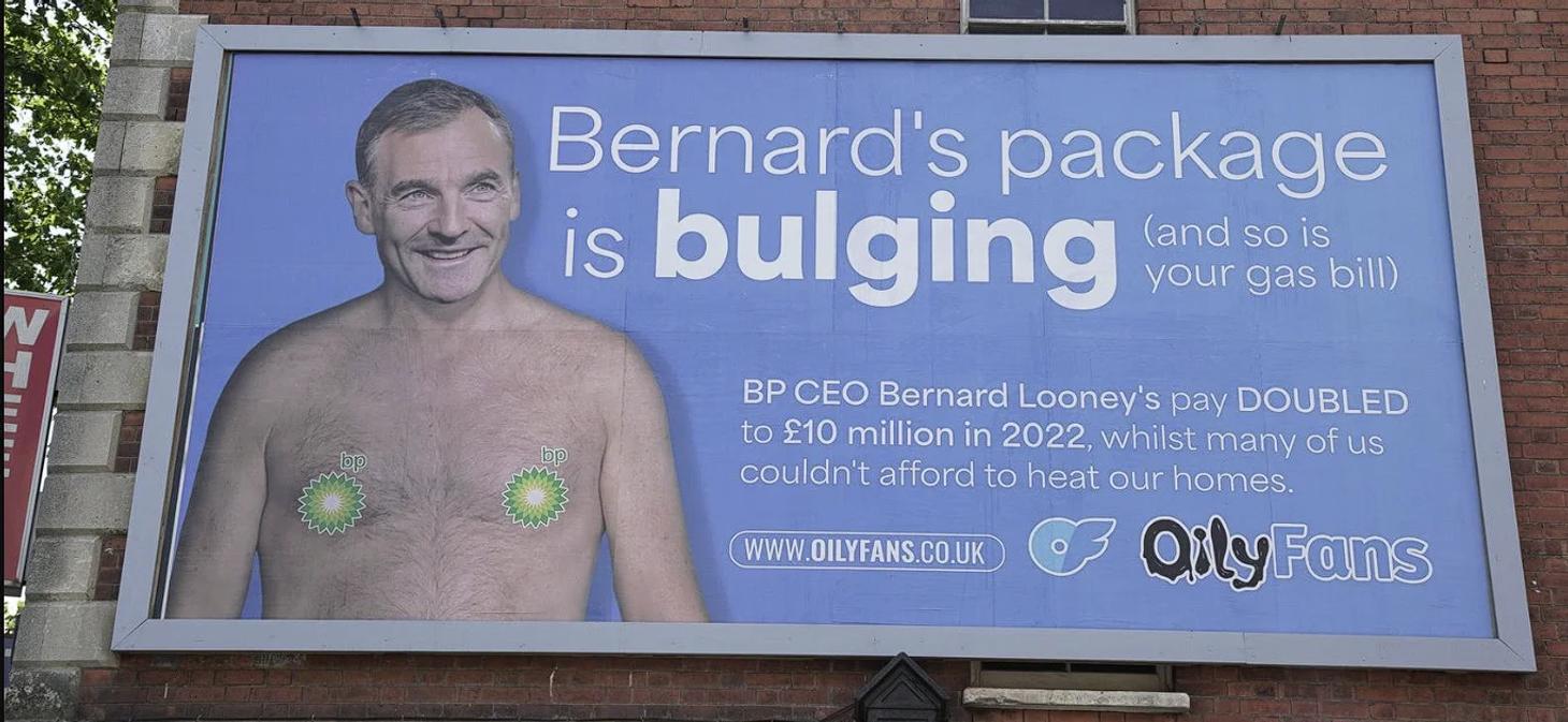 A blue billboard ad with the text “Bernard’s package is bulging” with a shirtless picture of BP CEO Bernard Looney.