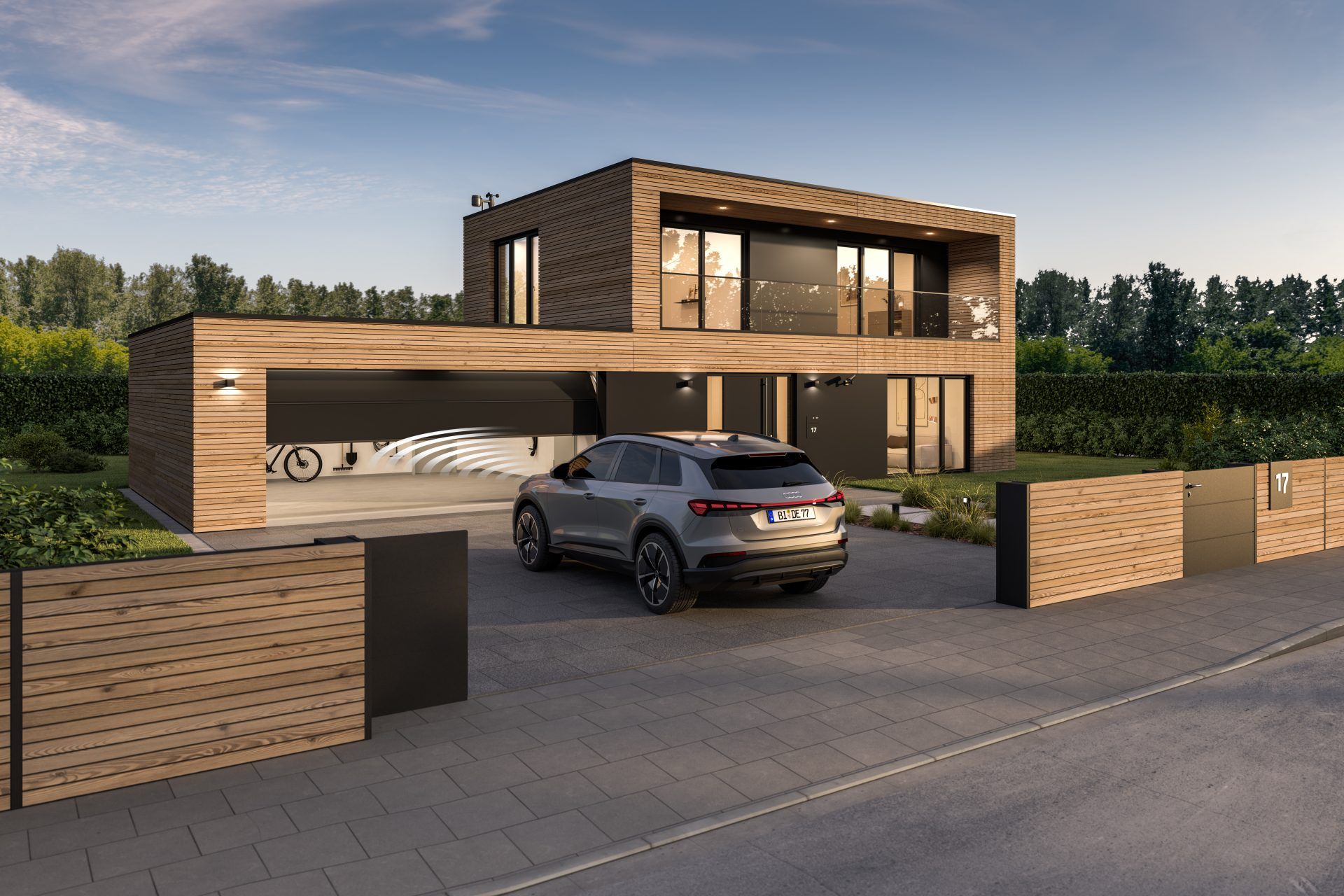Hörmann-Sektionaltor in Anthrazit RAL 7016, das sich per Fernbedienung vor einem Auto öffnet, an einem Haus mit Holzfassade