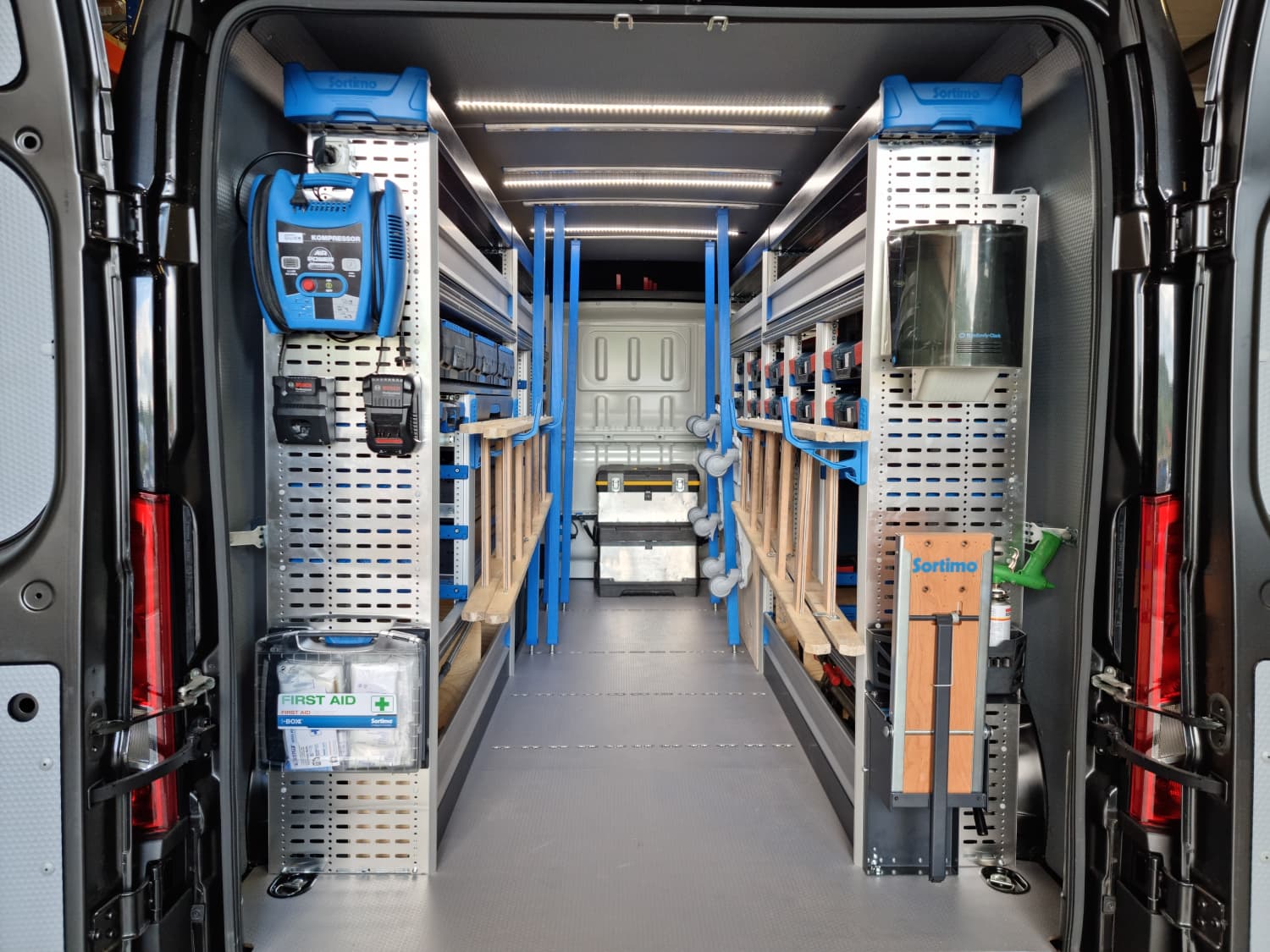 Load area of a Fermé-Lux van fitted out as a workshop: Sortimo racking, compressor, tools and first-aid kit