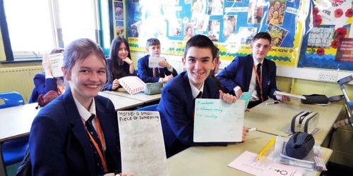 Learners at Ripley St Thomas Academy holding white boards