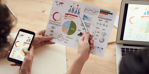 Two people looking at data on a graph