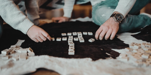 Two people playing a vocabulary game to improve their literacy.