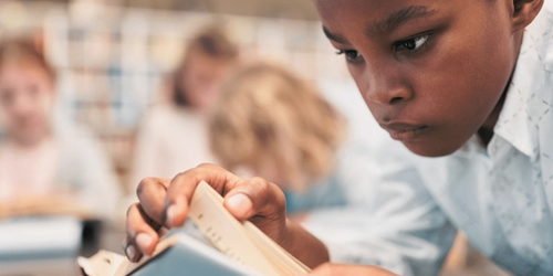 A student reading independently in the classroom