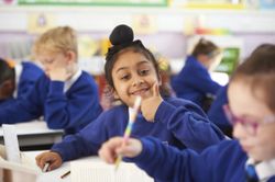 A learner at Queens Church of England Academy doing a thumbs-up to the camera.