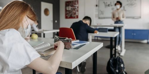 A student reading a book in class
