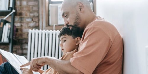A parent and child reading together