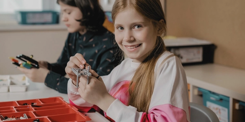 Two students working in a classroom.