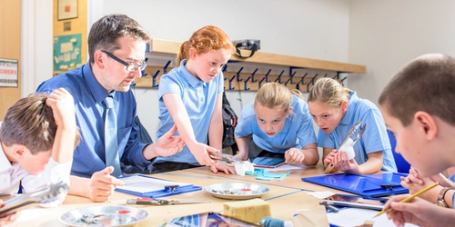 A teacher doing a science experiment with a class of students