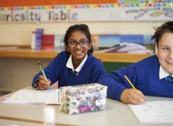 Learners at Queens Church of England Academy writing.