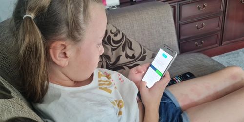 A child working on Bedrock on her phone