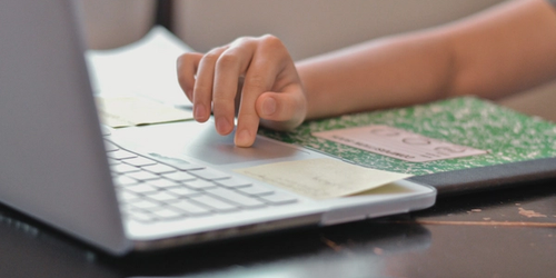 A student learning remotely on their laptop.