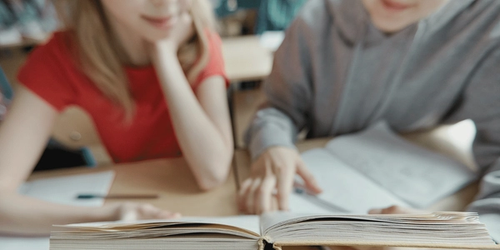 A parent and child reading together to improve literacy skills.
