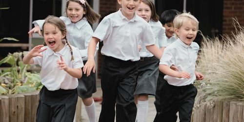 Students running outside of their school