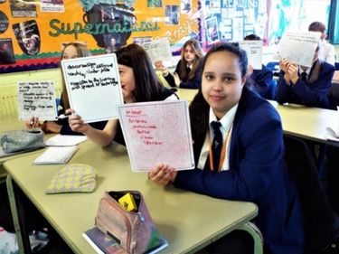Learners at Ripley St Thomas holding up whiteboards with Tier 2 vocabulary