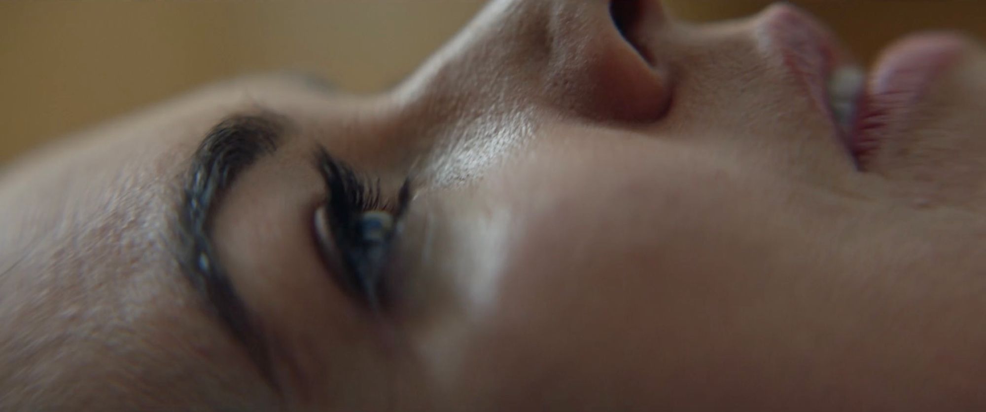 A woman's face resting sideways, in close-up.