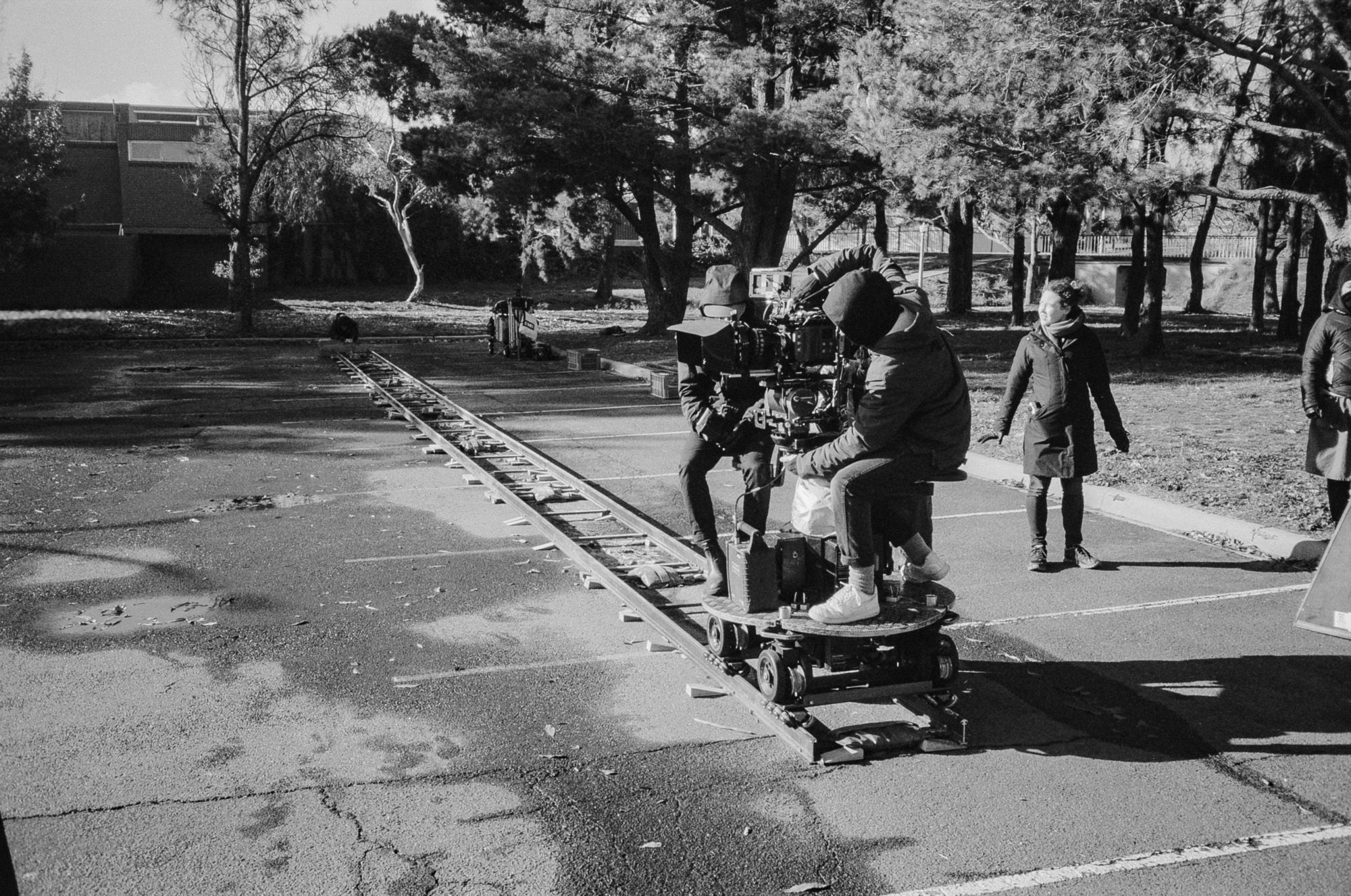Black and white photograph of people in a suburban street.