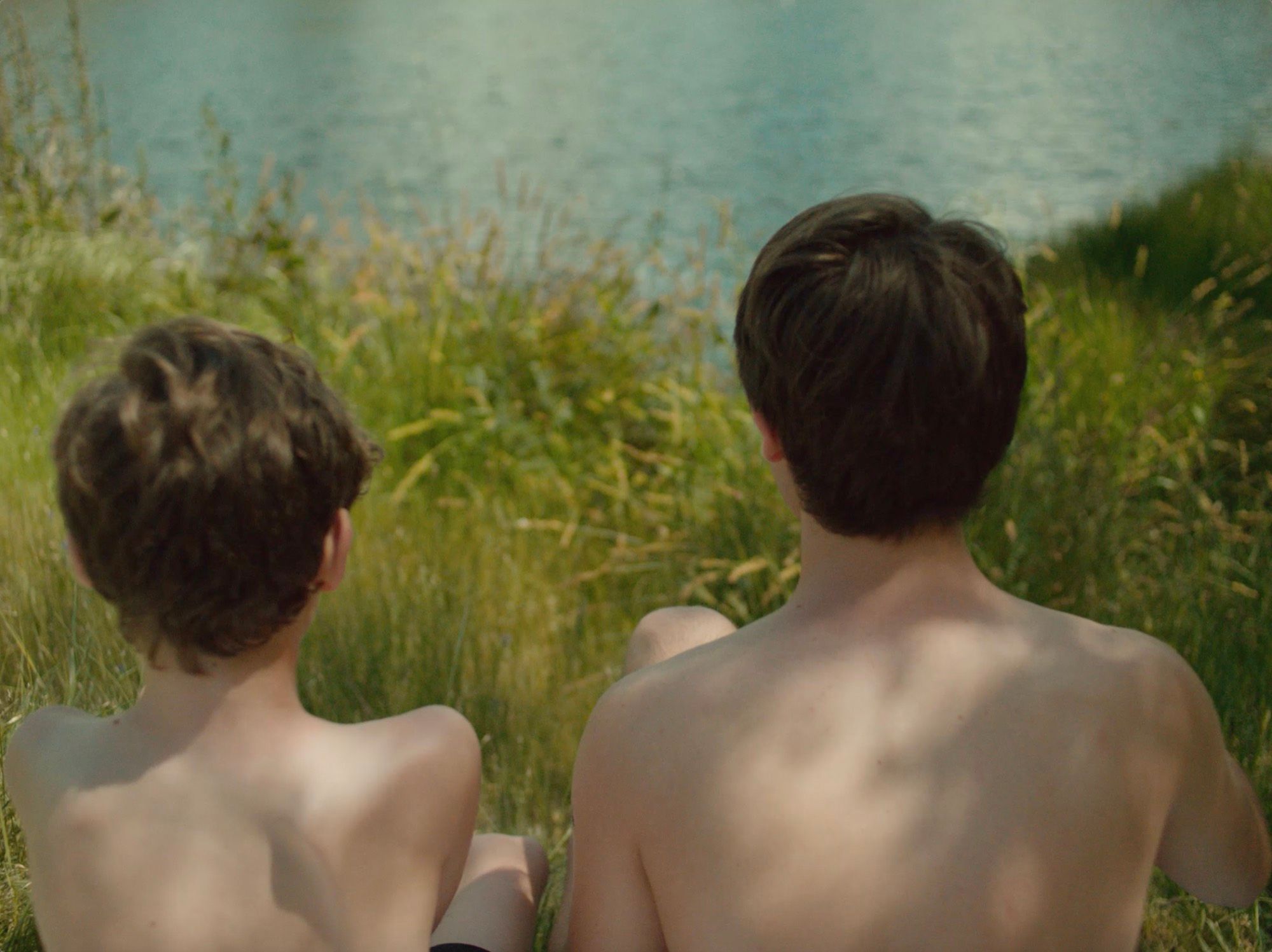 Two boys seen from behind.