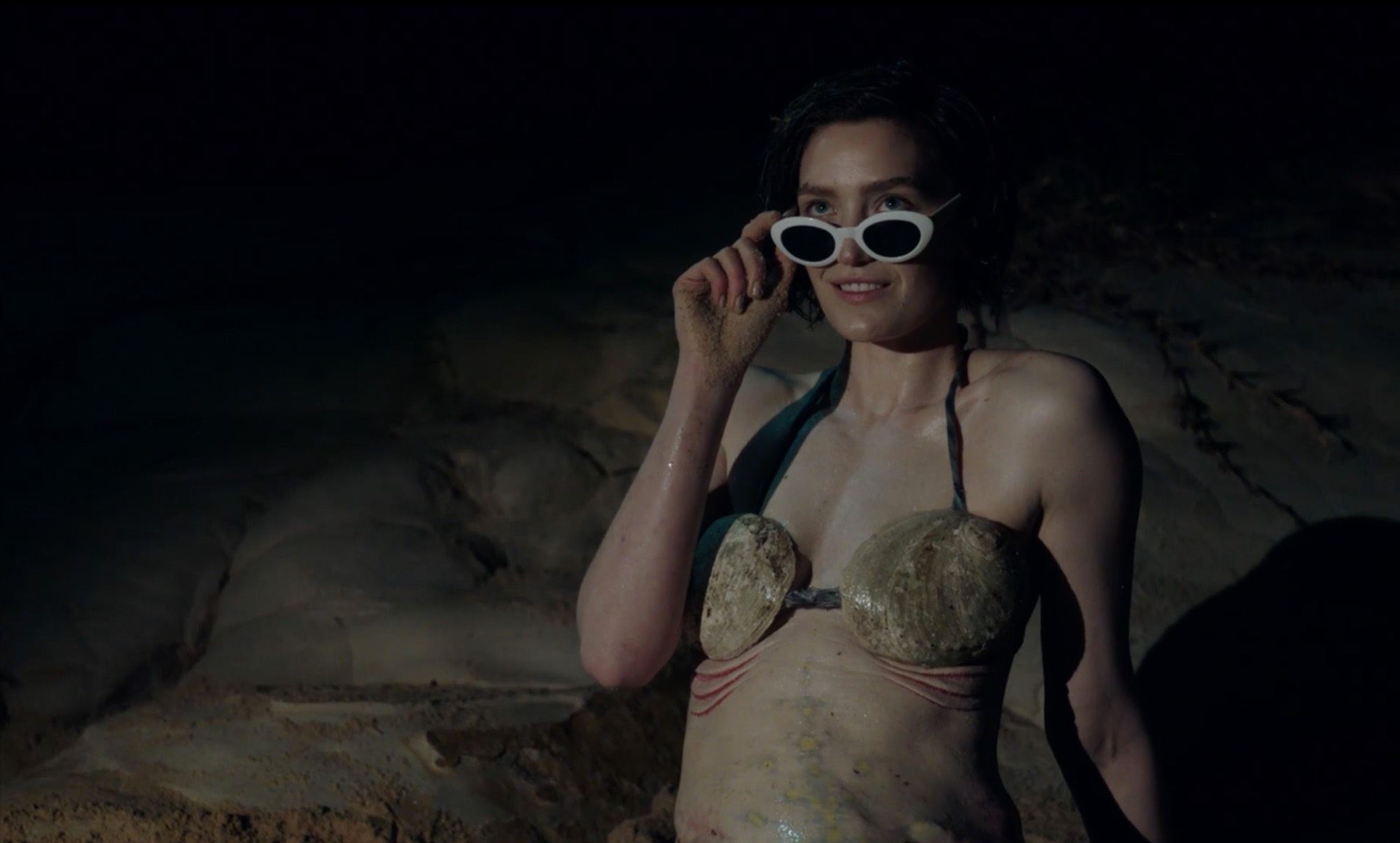 I F***ed a Mermaid and No One Believes Me: a figure in sunglasses at night.