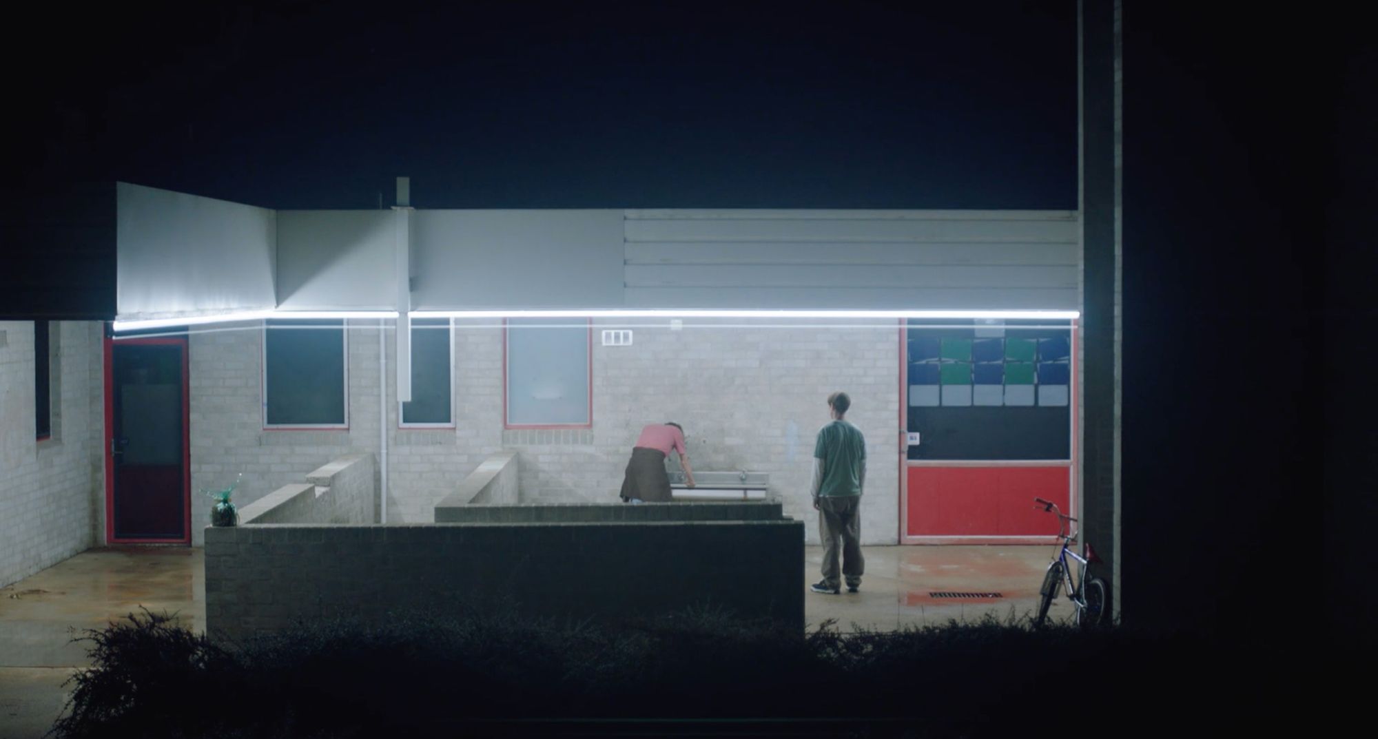 A suburban service station lit up at night.