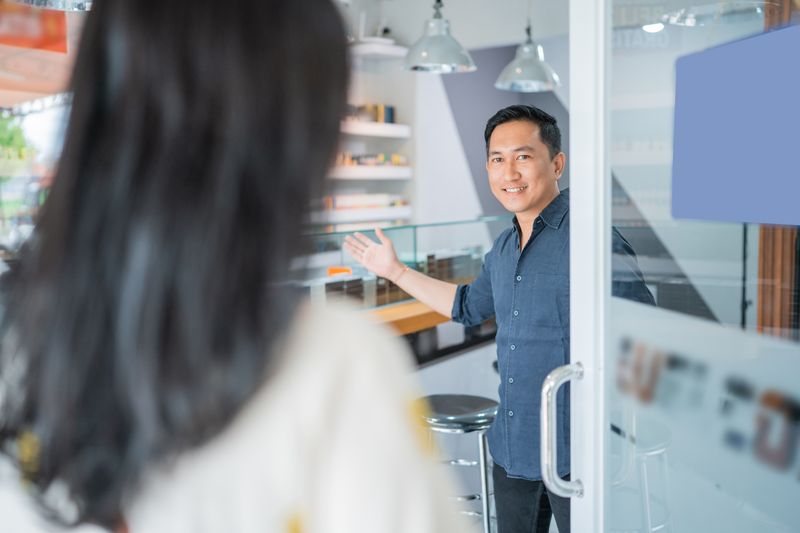 Smoke shop merchant welcoming a customer