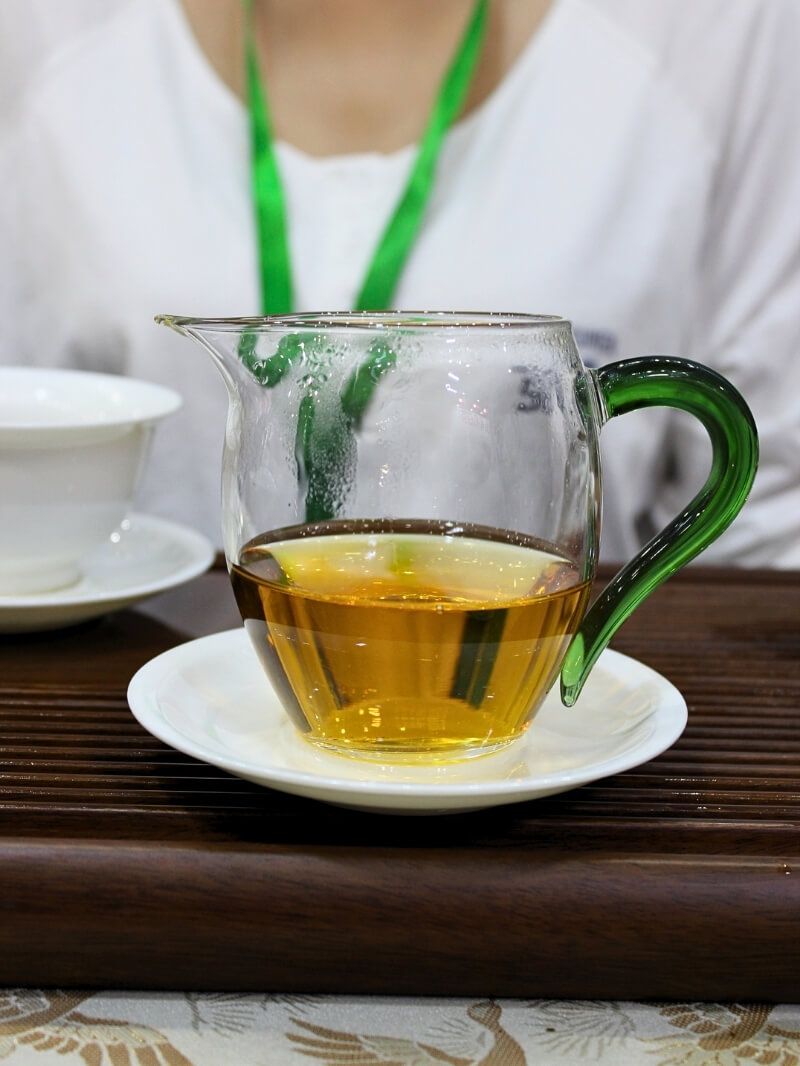 Sun-dried red tea liquor in a glass pitcher.